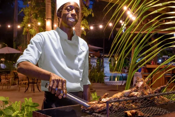 Chef grilling over an open flame